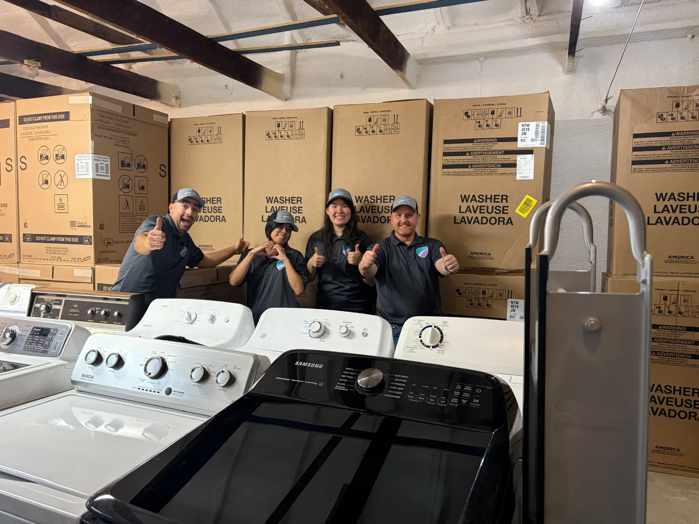The local ARC team with washer and dryer inventory in the warehouse